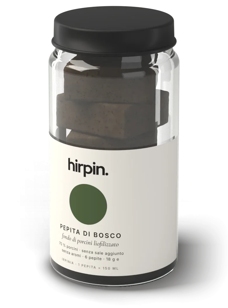 Vasetto di vetro hirpin. con capsula nera ed etichetta chiara con un disco verde: Pepita di bosco, fondo di porcini liofilizzato, sei pepite marroni impilate